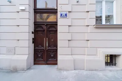 a wooden door on a building with a sign on it at M7 Main Square with Free Parking Friends Escape in Kraków