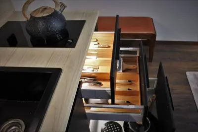 a kitchen with a wooden counter with a table with a pot at BOUTIQUE 109 - old city, luxury apt. with a garage in Kraków