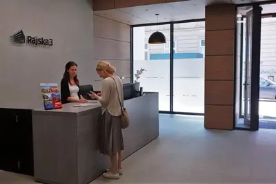 two women standing at a counter in an office at BOUTIQUE 109 - old city, luxury apt. with a garage in Kraków