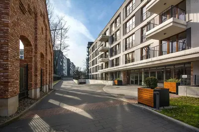 an empty street in a city with buildings at Rakowicka Top Apartaments Superior in Kraków