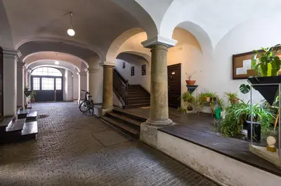 a large room with a staircase and some plants at LUXURY Apartment at the Main Square Tomasza street in Kraków