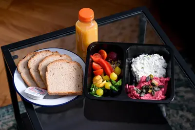 a tray of food with a plate of bread and a sandwich at Native Apartments Blich 7 in Kraków