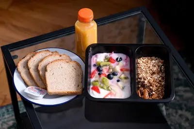 a lunch box with a plate of food and bread at Native Apartments Lubelska 14 in Kraków