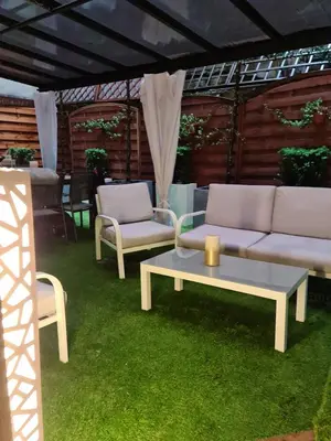 a living room with a couch and a table and chairs at AMBER APARTAMENt 10 in Kraków