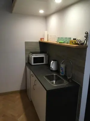 a small kitchen with a sink and a microwave at Pure Apartments in Kraków