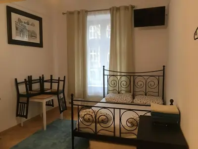 a bedroom with two beds and a window at Pure Apartments in Kraków