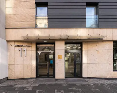 an entrance to an office building with revolving doors at Glossy Apart G9 in Kraków