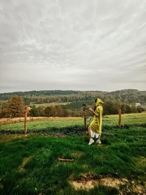 a man taking a picture of a field with a camera at LushHills - Tiny House - Modern House On Wheels in Regulice