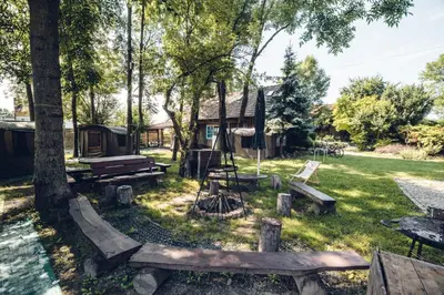 a park with picnic tables and a cabin at Pole Namiotowe Kogutowo in Wietrzychowice