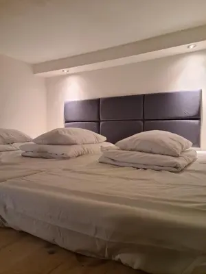 a large bed with two pillows on top of it at AMBER APARTAMENT 1112 in Kraków