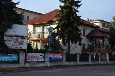 a house with signs on the side of a street at Apartament DeLuxe 2 in Oświęcim