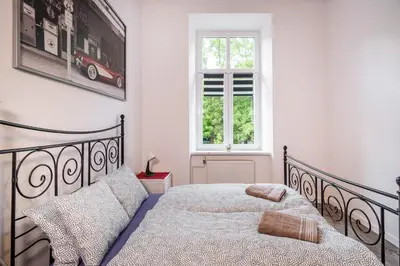 a bedroom with a black bed and a window at Krakus in Kraków