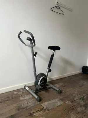 a exercise bike is parked next to a wall at Krakus in Kraków