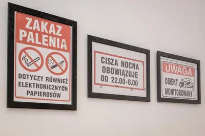 three framed signs hanging on a wall at KRAKOWIAK in Kraków