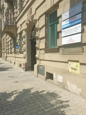 a building with a sign on the side of it at Apartament Moments Stare Miasto Style and Comfort Netflix in Kraków