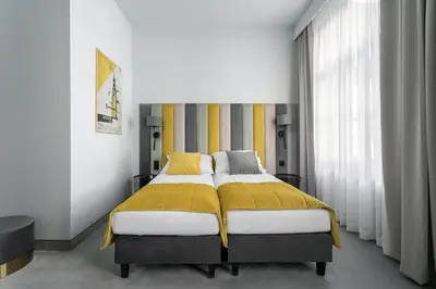 a bedroom with a bed with a yellow blanket at Old Town Residence - Premium Aparthotel in Kraków