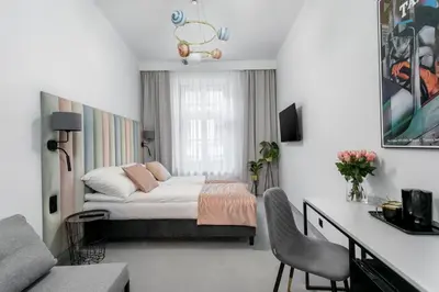 a bedroom with a bed and a desk in it at Old Town Residence - Premium Aparthotel in Kraków