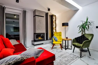 a living room with a red couch and chairs at Nowoczesne Apartamenty typu Superior - Bulwary Rabka Zdrój - Balia - Blisko Park Zdrojowy in Rabka