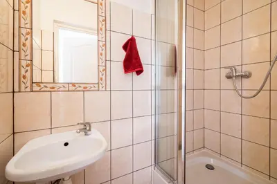 a bathroom with a shower and a sink and a mirror at Caramba in Kraków