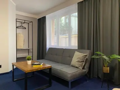a living room with a couch and a table at Garbarska 22 Aparthotel in Kraków