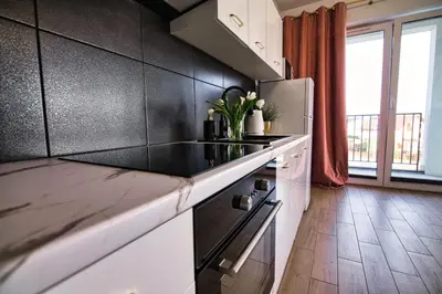 a balcony with a table and chairs on a balcony at Apartament The Palm 35 by Housine in Zator