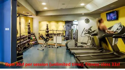 a gym with tread machines and a woman on a treadmill at Premium Apartment for Old Town & Jewish Quarter plus Pool in Kraków