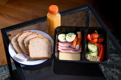 a lunch box with a sandwich and a plate of food at Native Apartments Paulińska 20 Superior in Kraków