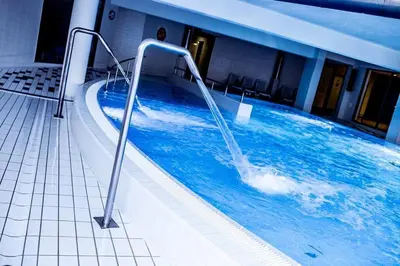 a swimming pool with a water feature in a building at Premium Apartment for Jewish Quarter & Old Town plus Pool in Kraków