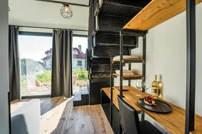 a dining room with a table and a window at Domki na Łące in Libiąż