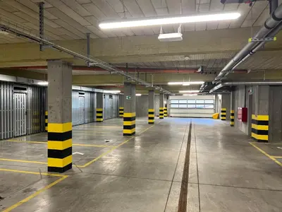 an empty parking garage with yellow and black poles in it at Apartament No 34 Green - Holiday Home Zator in Zator