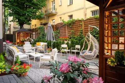 a large building with cars parked in front of it at Amber Boutique Hotels - Hotel Amber in Kraków
