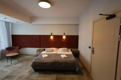 a hotel room with a bed and a chair at Kraków Garden Hotel- jesteśmy w trakcie modernizacji in Kraków