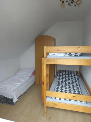a bedroom with two bunk beds and a bed at Mieszkanie A Łowiczki in Zator