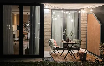 a patio with a table and a chair and a house at #2 OLIVE Apartment City Center FREE GARAGE in Kraków