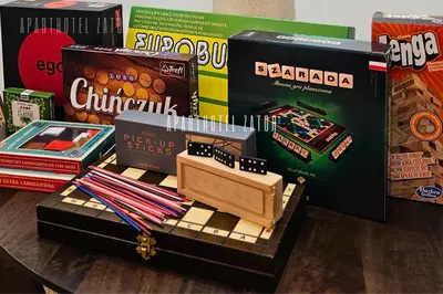 a table with a toy train and boxes of books at Aparthotel ZATOR Glam 52 jacuzzi in Zator