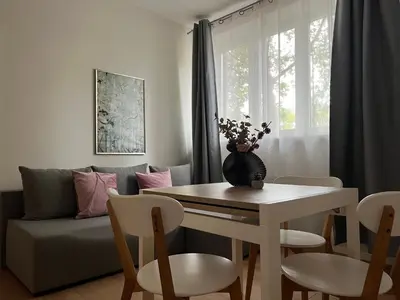 a living room with a table and a couch at Modern & cozy flat - near to Wawel Castle in Kraków