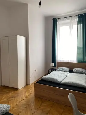 a bedroom with a large bed and a window at Best View Old Town Rooms in Kraków