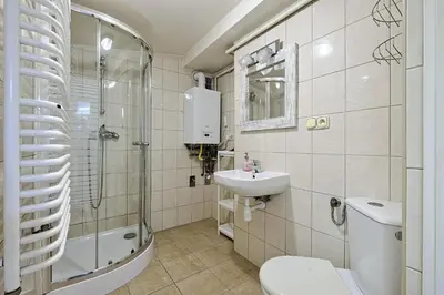 a bathroom with a toilet and a sink and a shower at Urban Nest Apartments Szewska 21 in Kraków