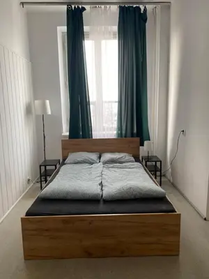a bedroom with a wooden bed with a window at Amazing view rooms in Old Town in Kraków