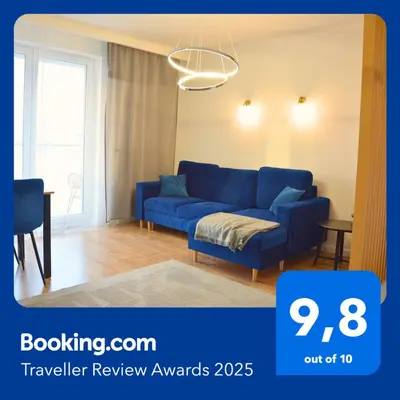 a blue couch sitting in a living room at Apartament na wynajem 32 m2 in Bochnia