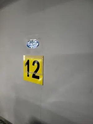 a yellow sign with the number on a wall at AMBER APARTAMENt 519 in Kraków