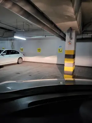 a parking garage with a car parked in it at AMBER APARTAMENt 127 in Kraków