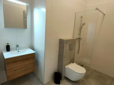a bathroom with a toilet and a sink and a shower at Hugo VIP Apartments in Kraków
