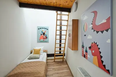 a room with a bed and a ladder in it at Urban Nest Apartments Augustiańska 4 in Kraków