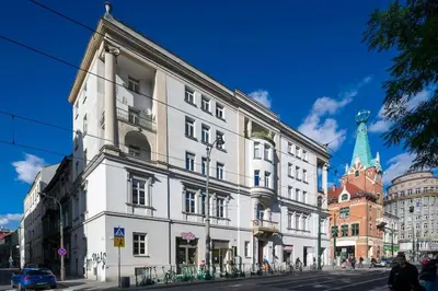 a large white building on a city street at Modern apartment in the very central location 20 in Kraków