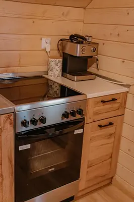 a kitchen with a stove and a coffee maker at Apartament Sosnowy Domek Piętro Zator Graboszyce in Graboszyce