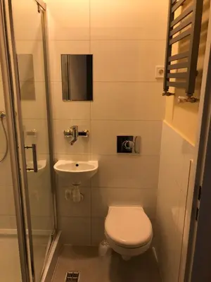 a small bathroom with a toilet and a sink at PIRANIA in Kraków